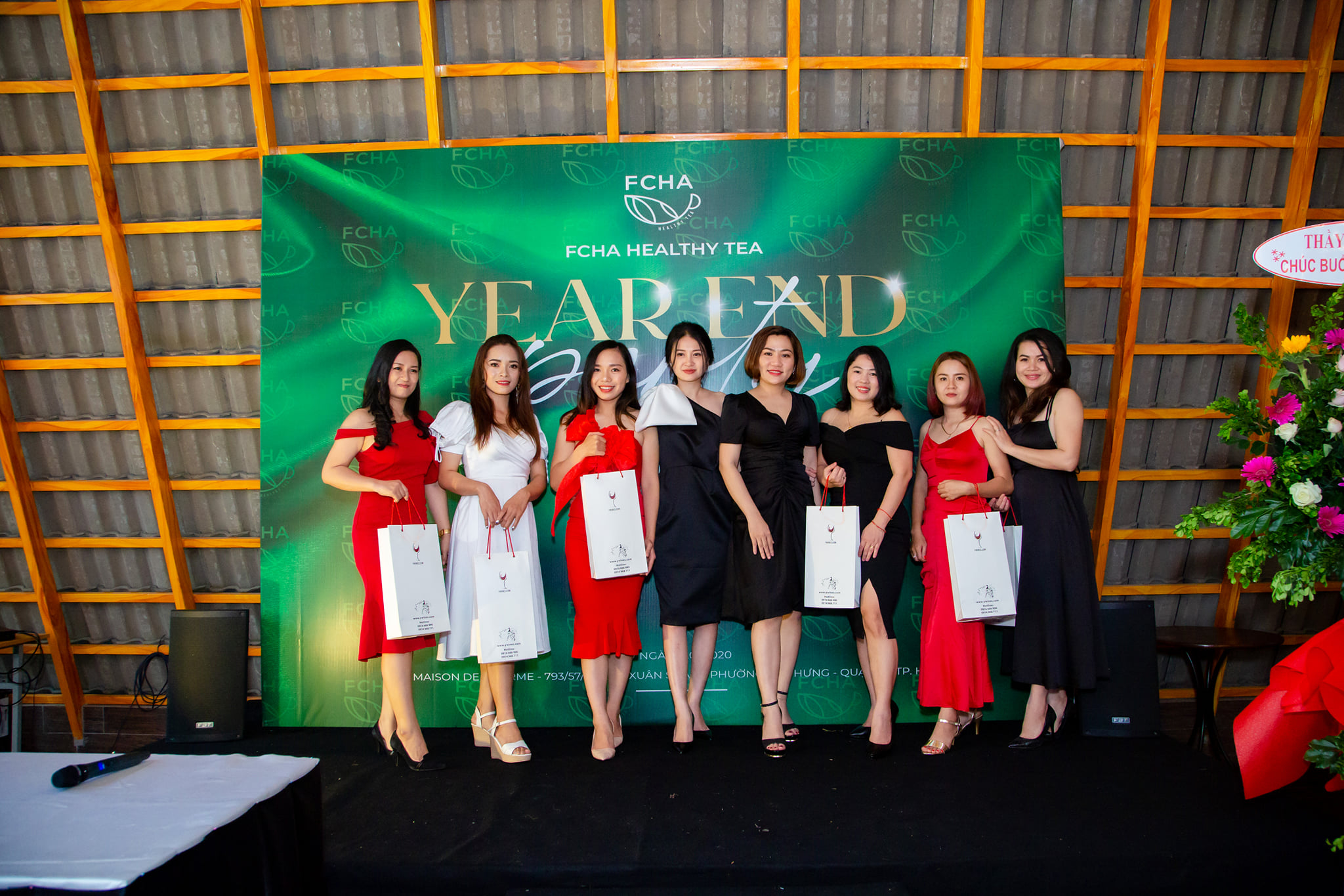 Nhân viên công ty chụp ảnh check-in tại backdrop tiệc tất niên